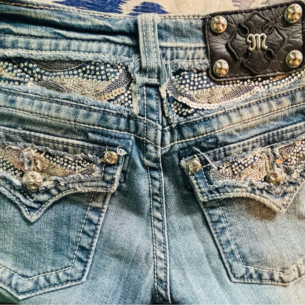 Miss Me Light Blue Boot Cut Jeans with Sequin-Embellished Back Pockets.